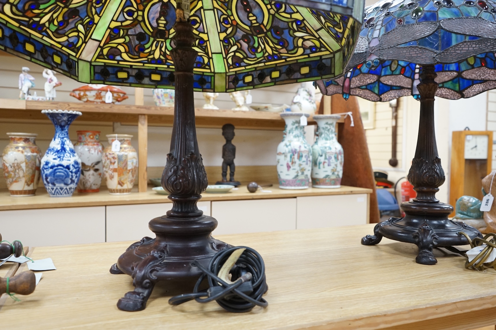 Two Tiffany style table lamps, with ornate glass and metal shades, tallest 72cm high